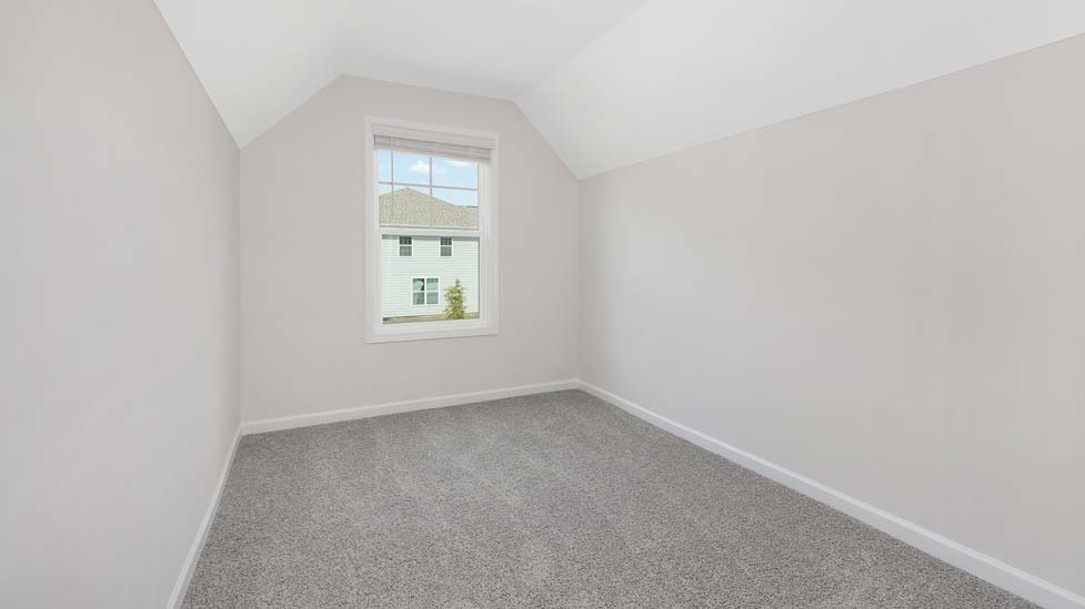 Carpeted bedroom with windows