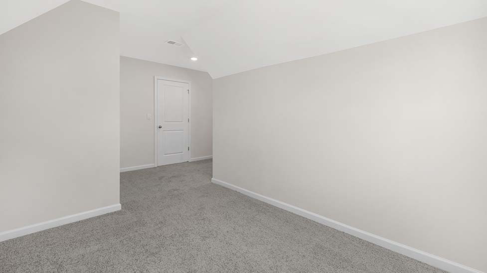 Carpeted bedroom with windows
