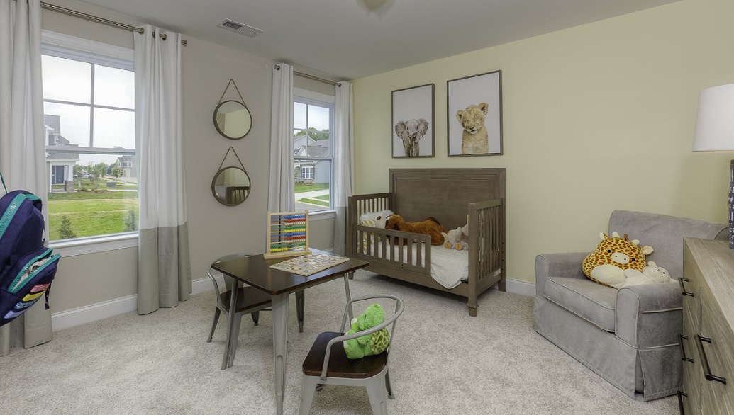 Carpeted bedroom with two small windows