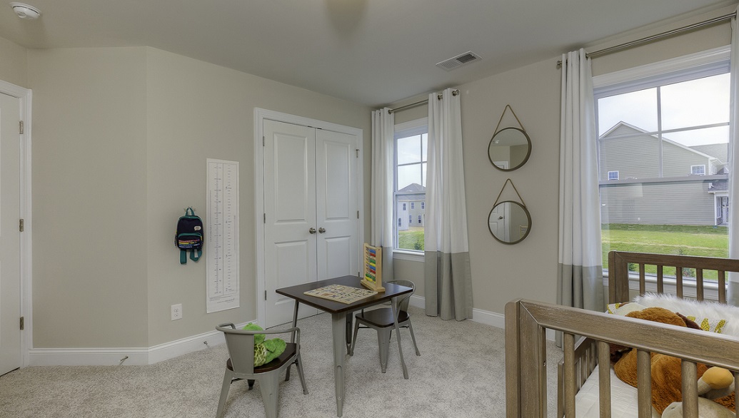 Carpeted bedroom with two small windows
