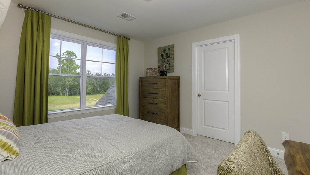 Carpeted bedroom with large window