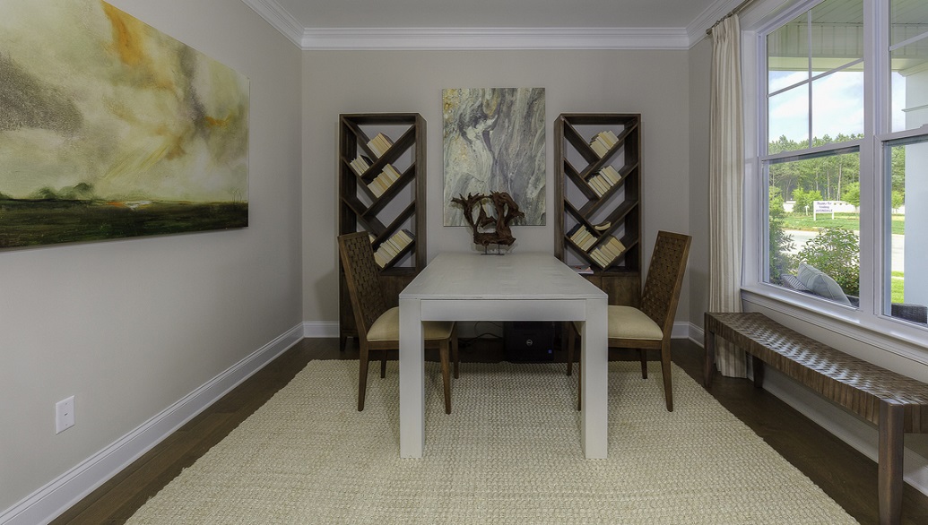 Formal living room space with wood floors and large window