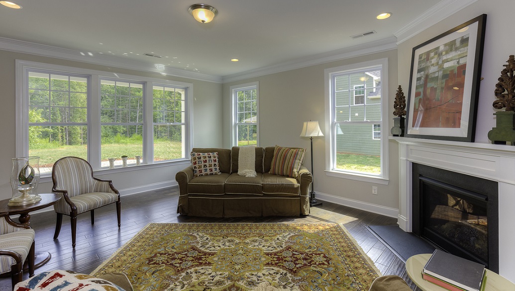 Family room with wood floors, fireplace and many large windows