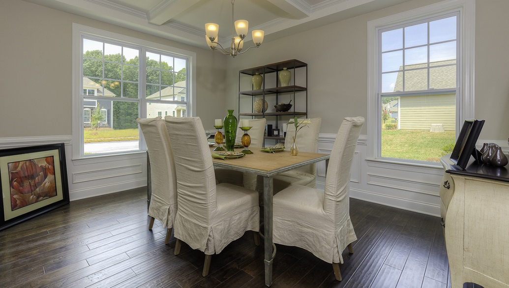 Dining room with wood floors and two large windows