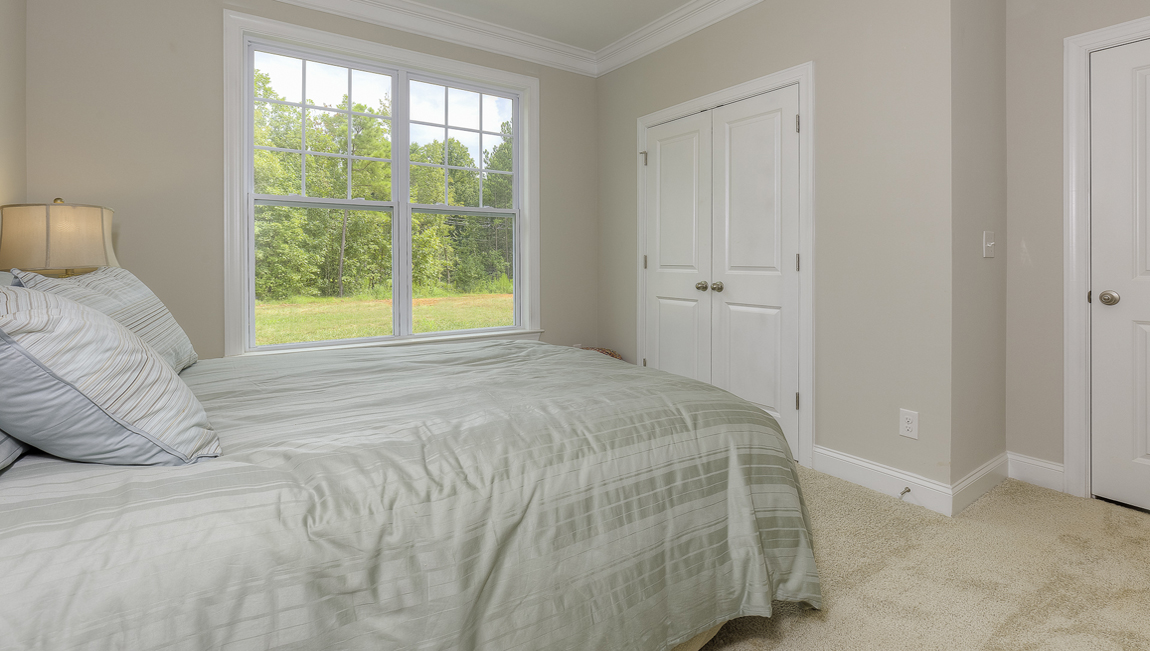 carpeted bedroom with large window