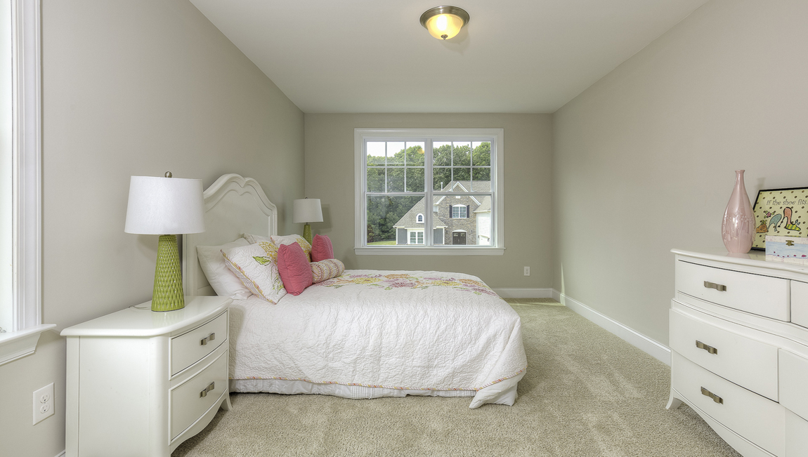 Carpeted bedroom with large window