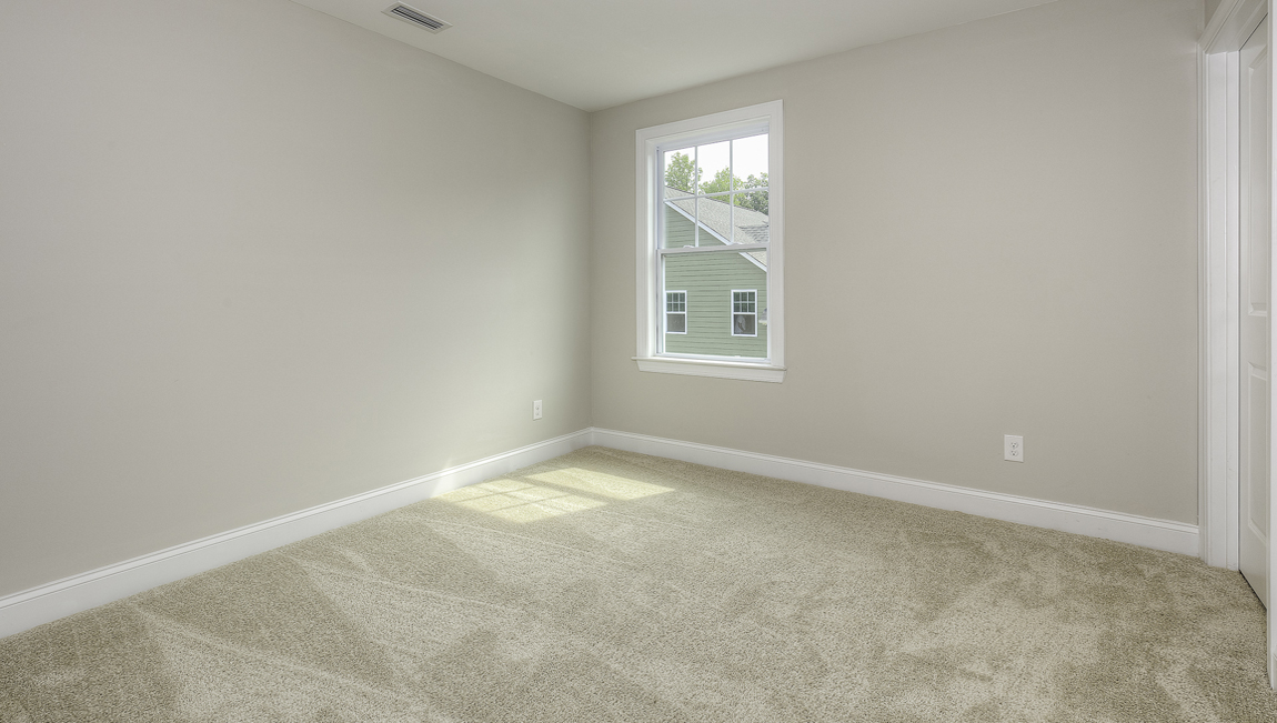 Carpeted bedroom with large window