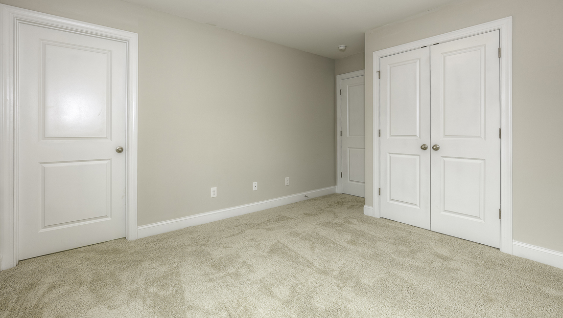Carpeted bedroom with large window