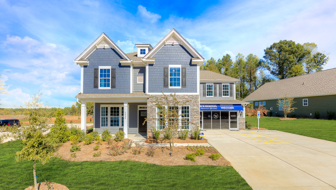 Kristin front exterior with stone, grey siding, front porch and two car garage