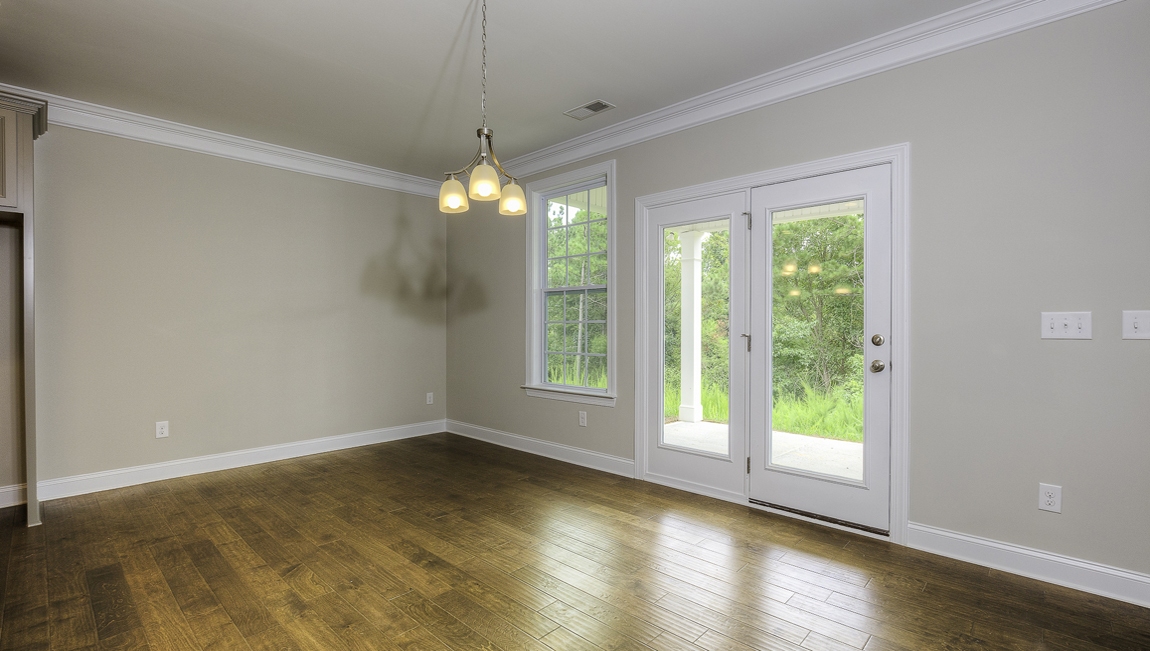 Breakfast area beside kitchen with small window and back door