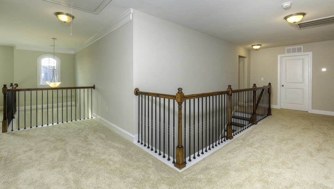 Upstairs loft with carpet and small windows