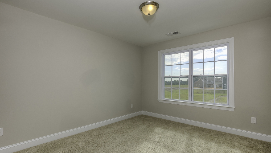Carpeted bedroom with large window