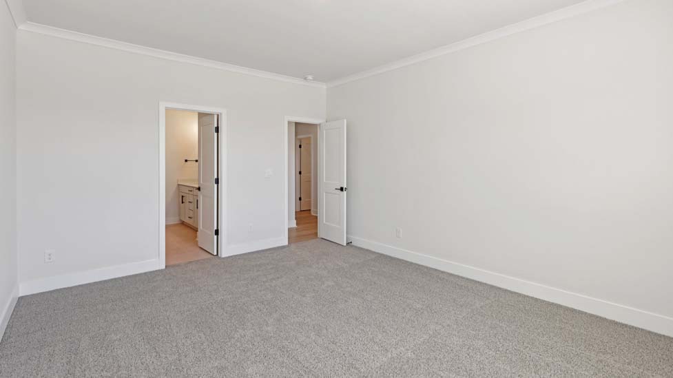 Carpeted bedroom with large window