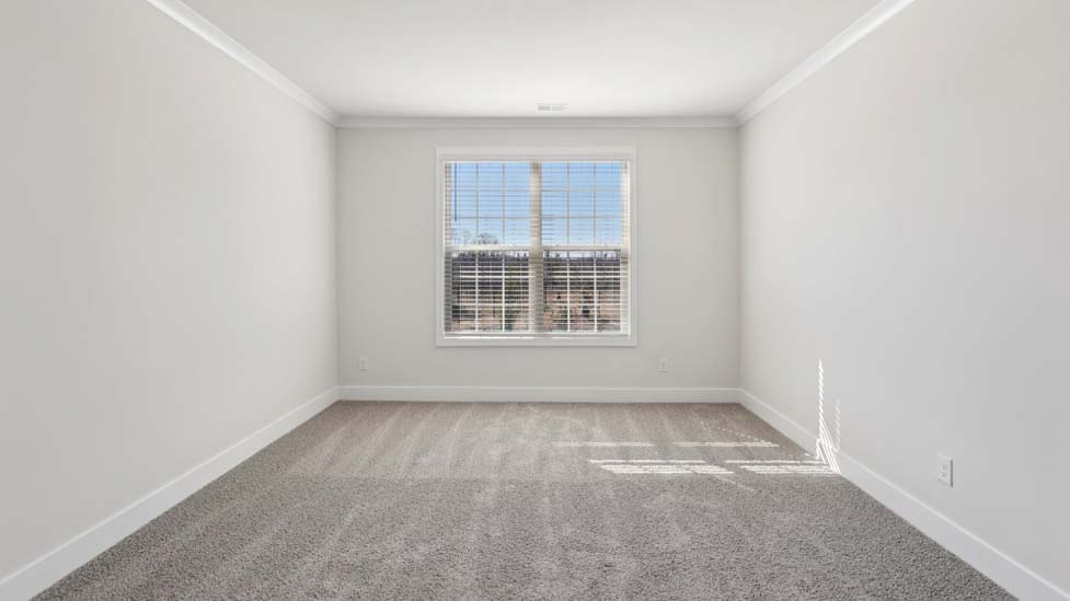 Carpeted bedroom with large window