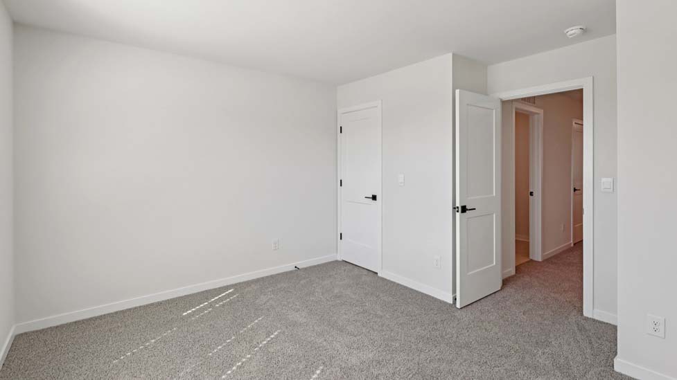 Carpeted bedroom with large window