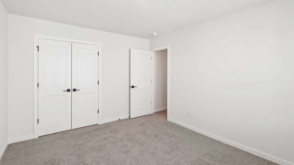 Carpeted bedroom with large window