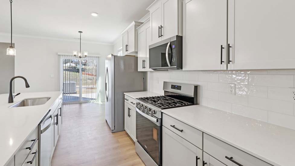 Kitchen and island with stainless steel appliances