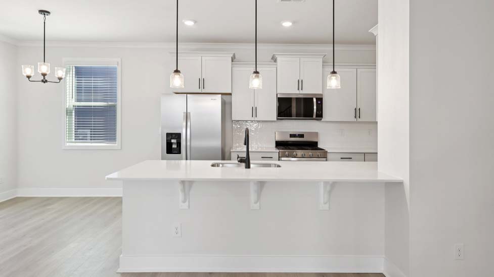 Kitchen and island with white cabinets