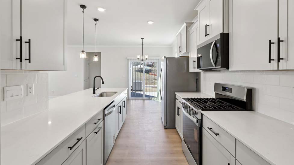 Kitchen and island with white cabinets