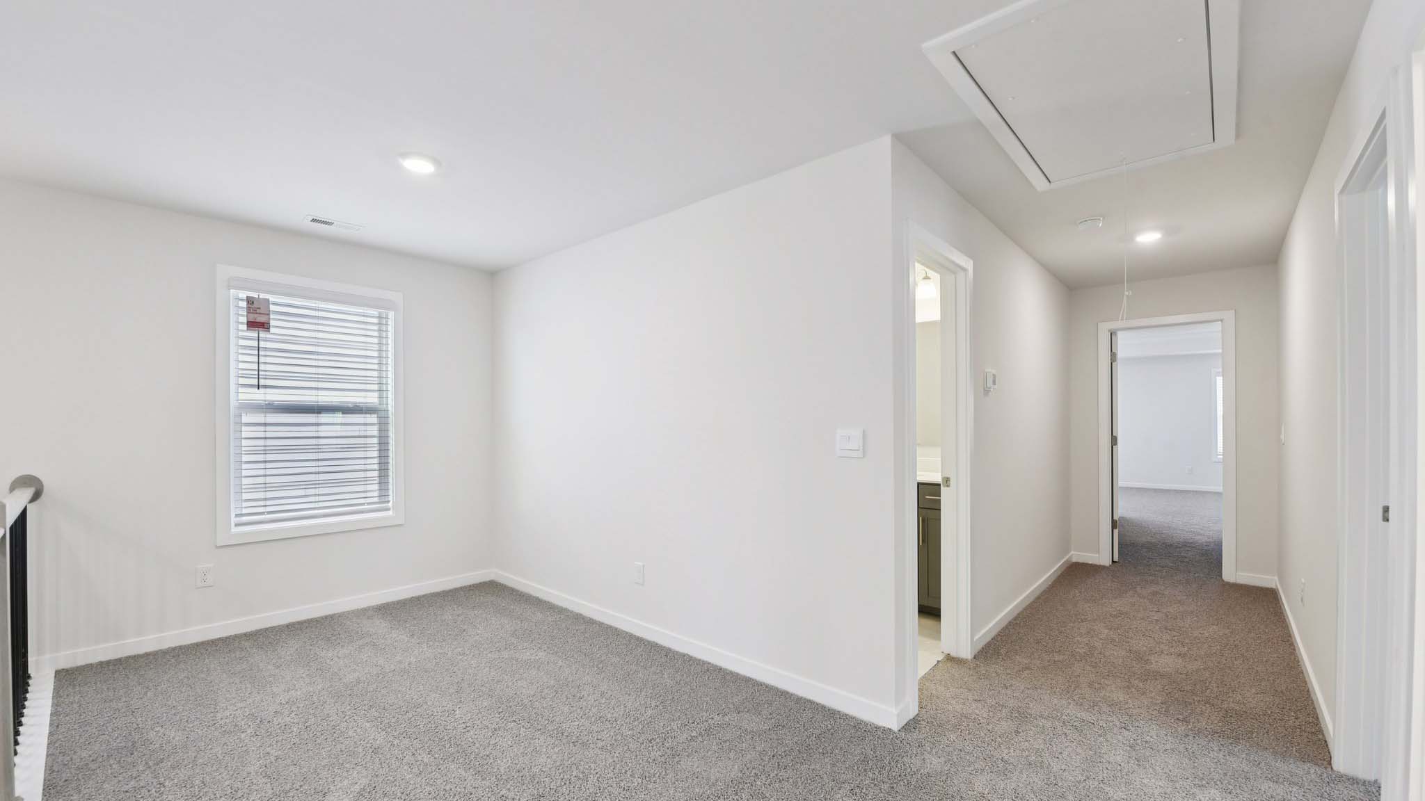 Carpeted bedroom with large window