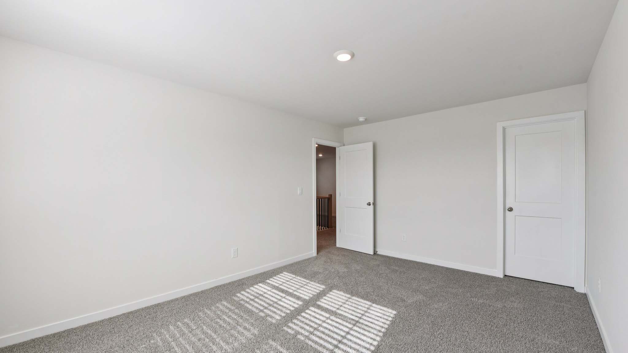 Carpeted bedroom with large window