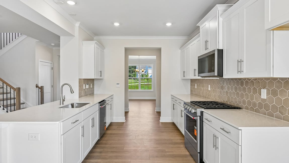 Kitchen and island with stainless steel appliances