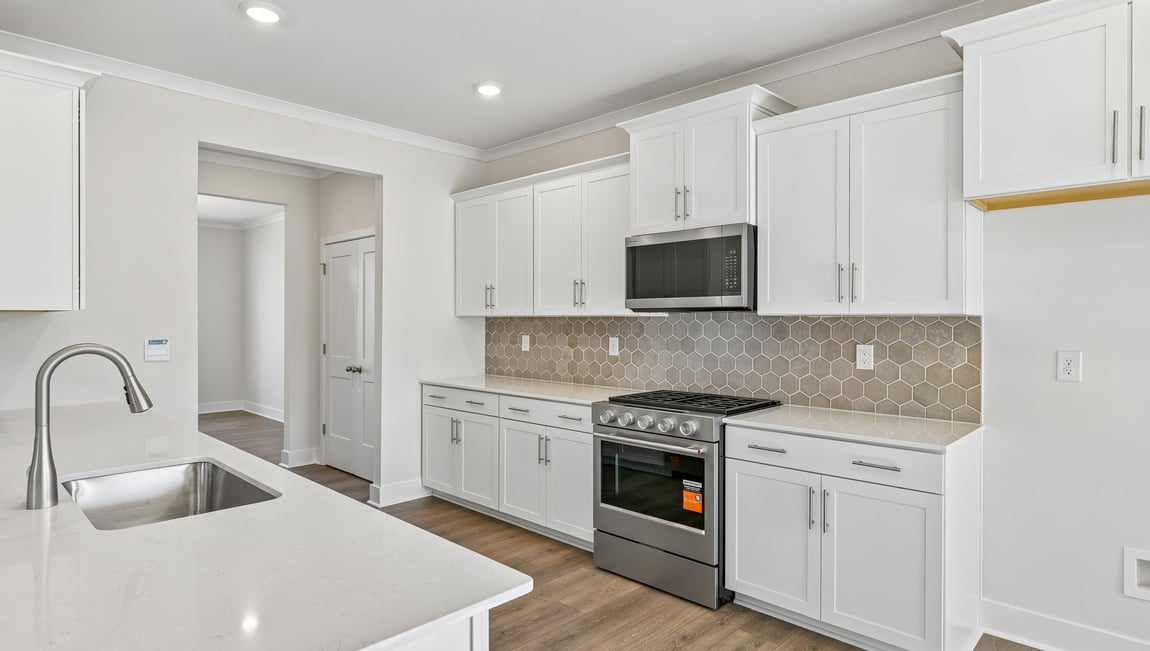 Kitchen and island with stainless steel appliances