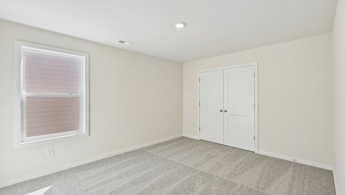 Carpeted bedroom with large window
