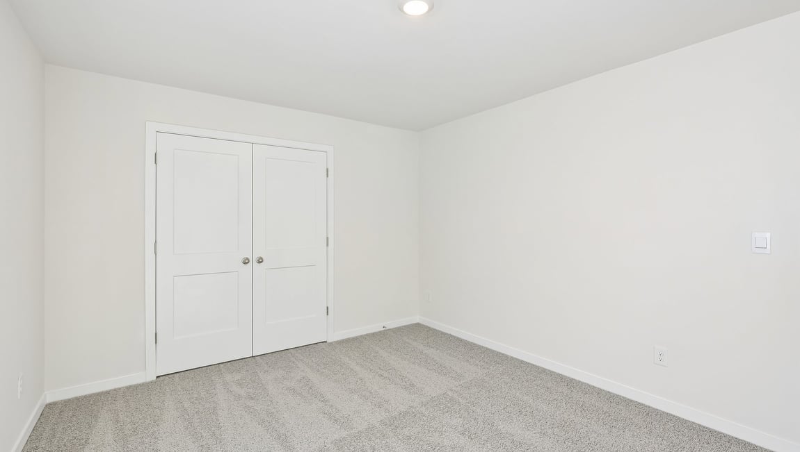 Carpeted bedroom with large window