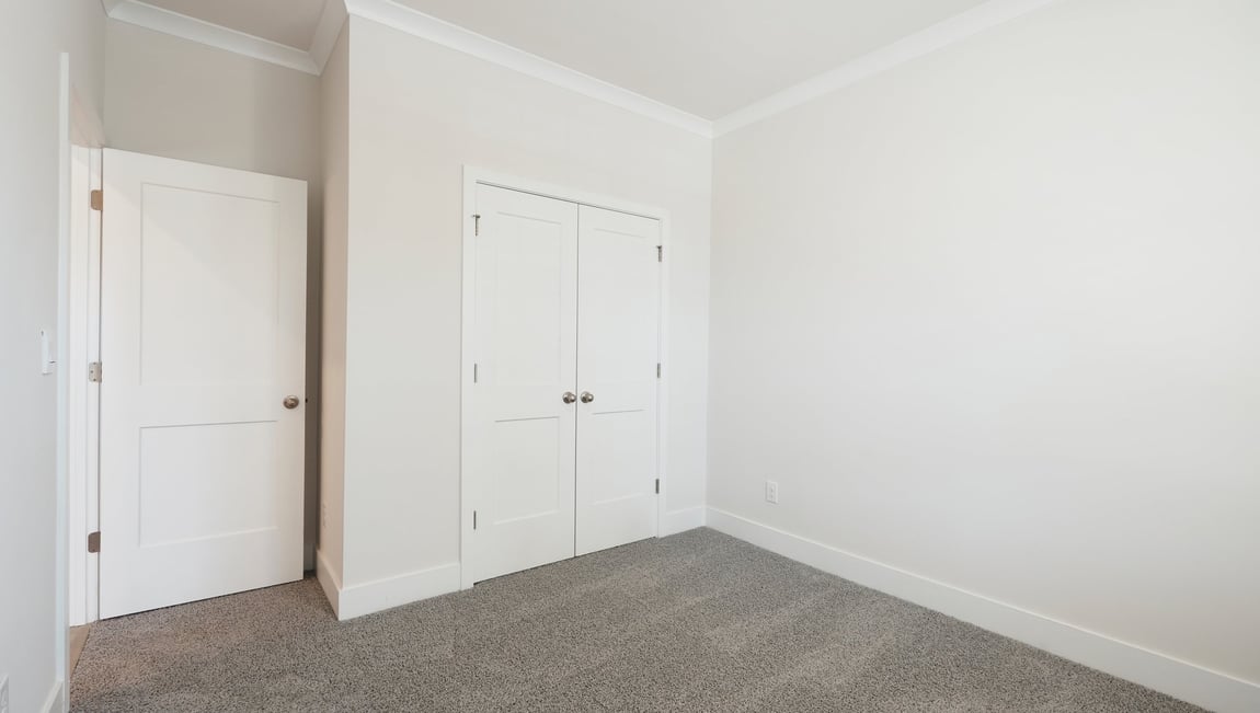 Carpeted bedroom with large window