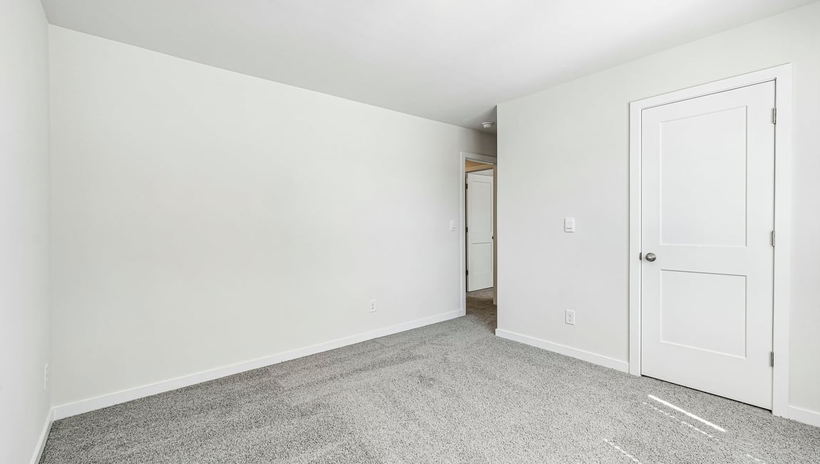 Carpeted bedroom with large window