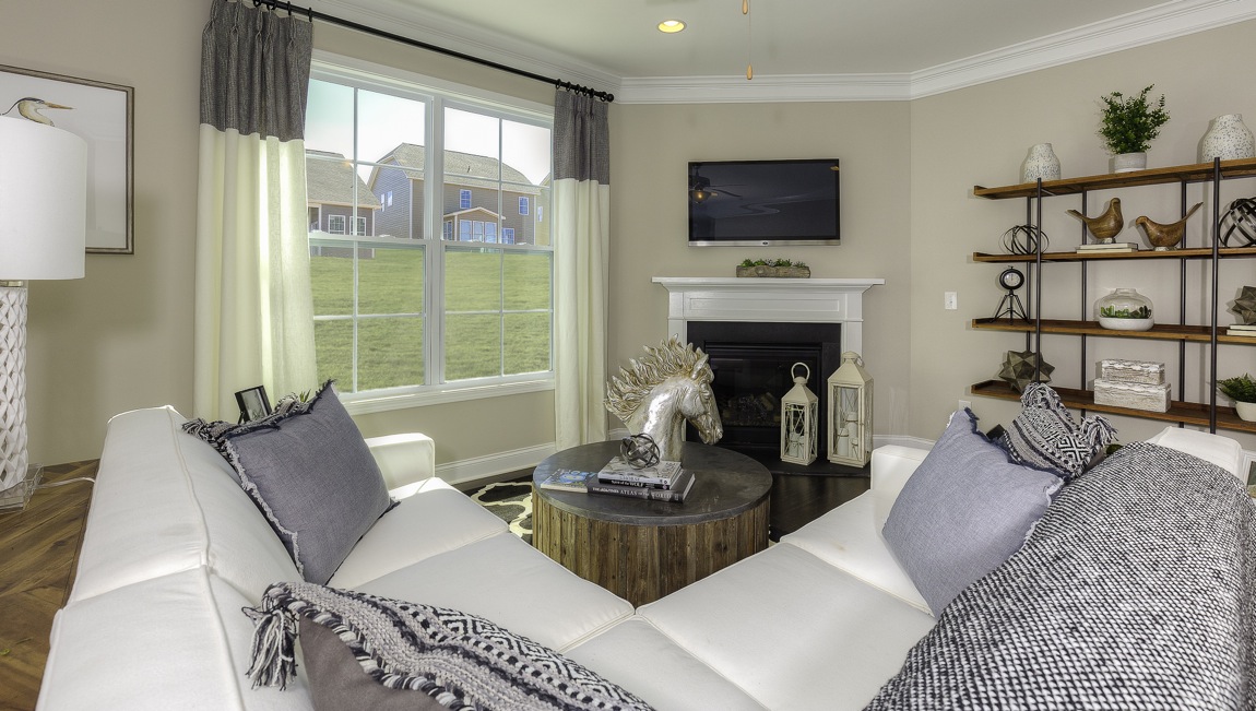 family room with large window and fireplace