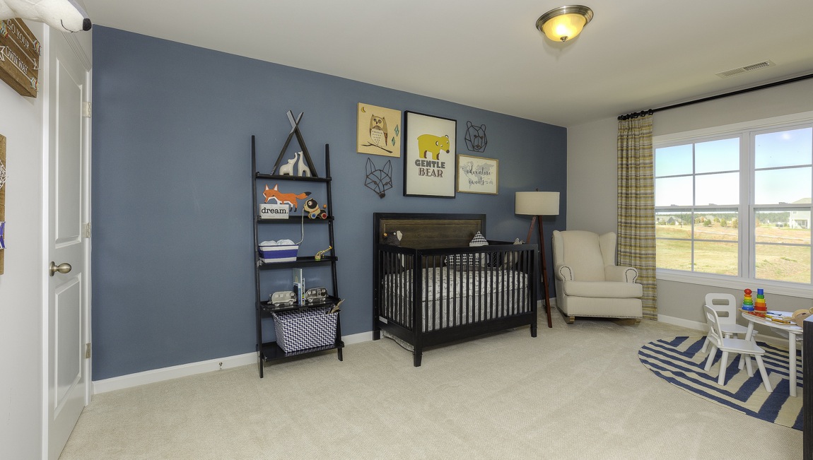 carpeted bedroom with large window