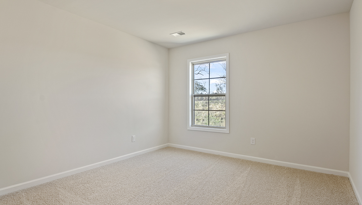 carpeted bedroom with large window