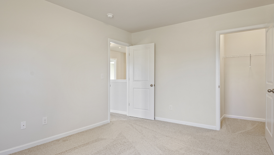 carpeted bedroom with large window