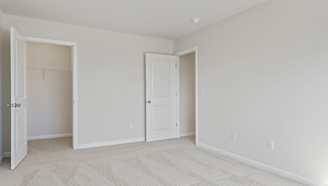 carpeted bedroom with large window