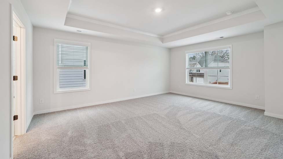carpeted bedroom with large window