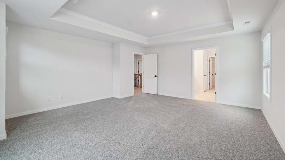 carpeted bedroom with large window