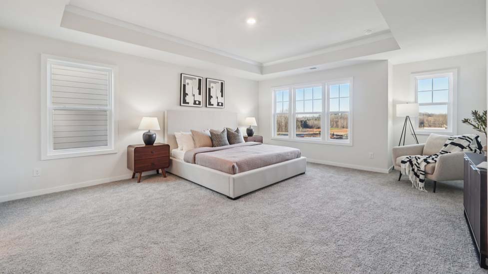 carpeted primary bedroom with large window