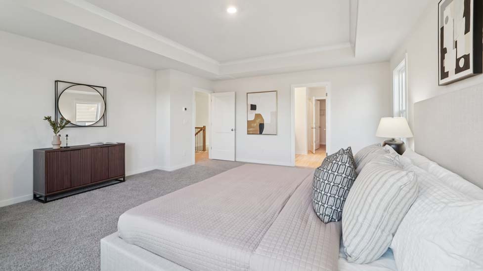 carpeted primary bedroom with large window