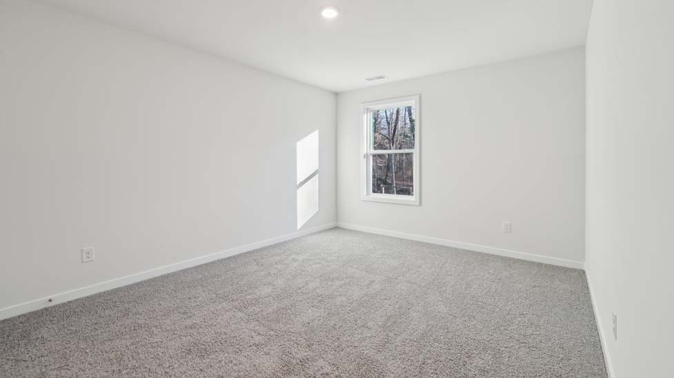 carpeted bedroom with large window