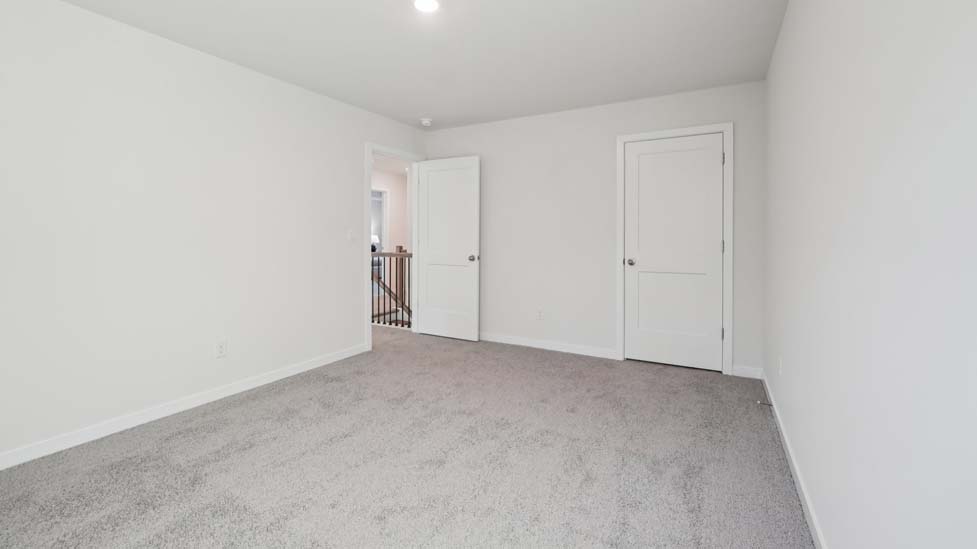 carpeted bedroom with large window