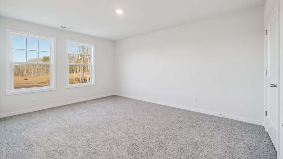 carpeted bedroom with large window