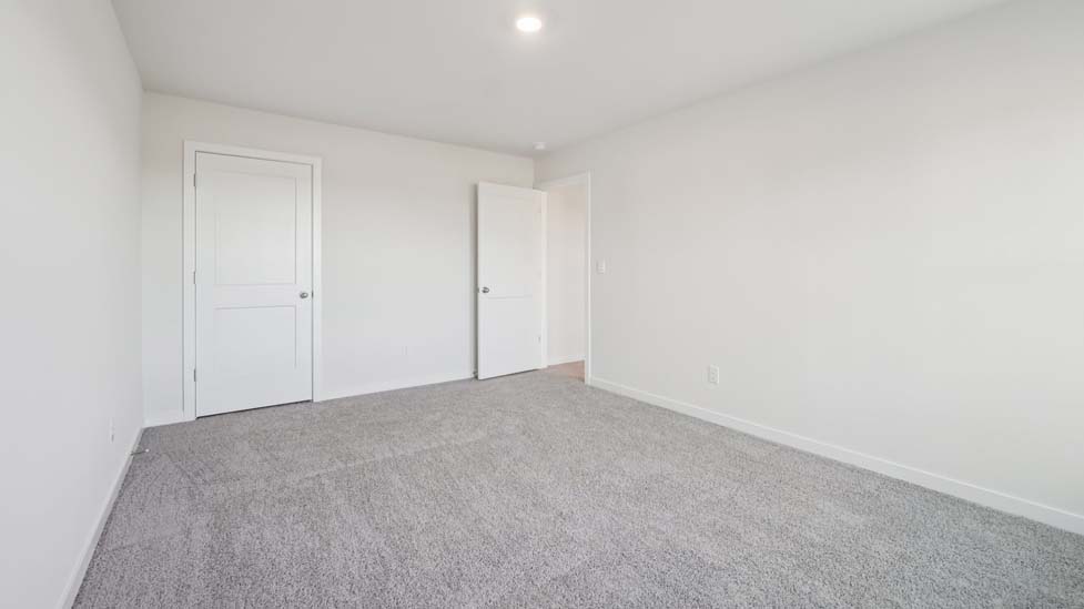 carpeted bedroom with large window
