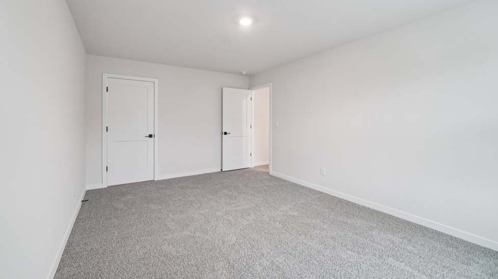 carpeted bedroom with large window