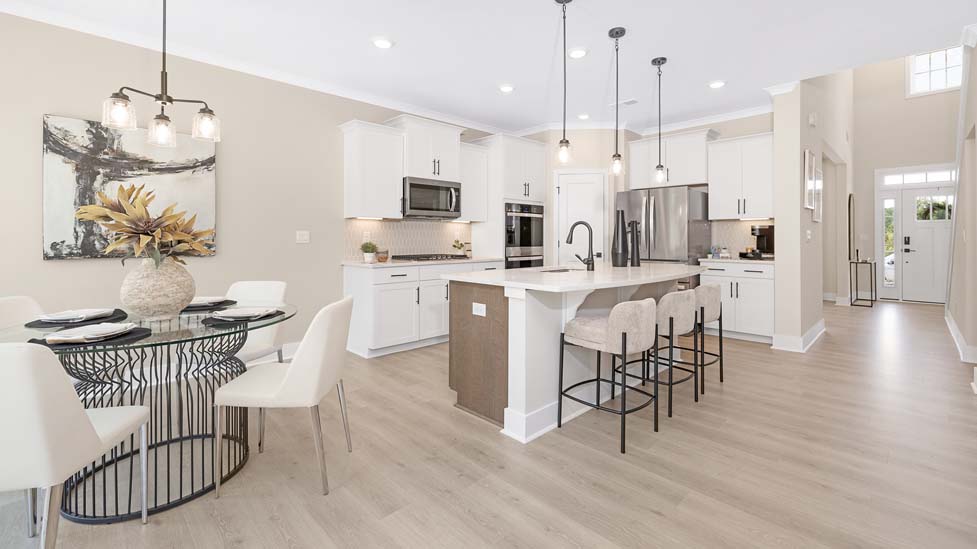 kitchen and island with white cabinets and stainless steel appliances