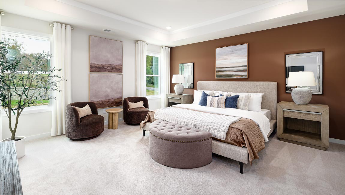 Primary carpeted bedroom with windows