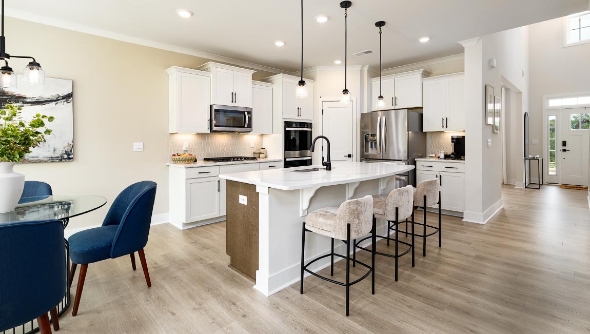 kitchen and island with white cabinets and stainless steel appliances
