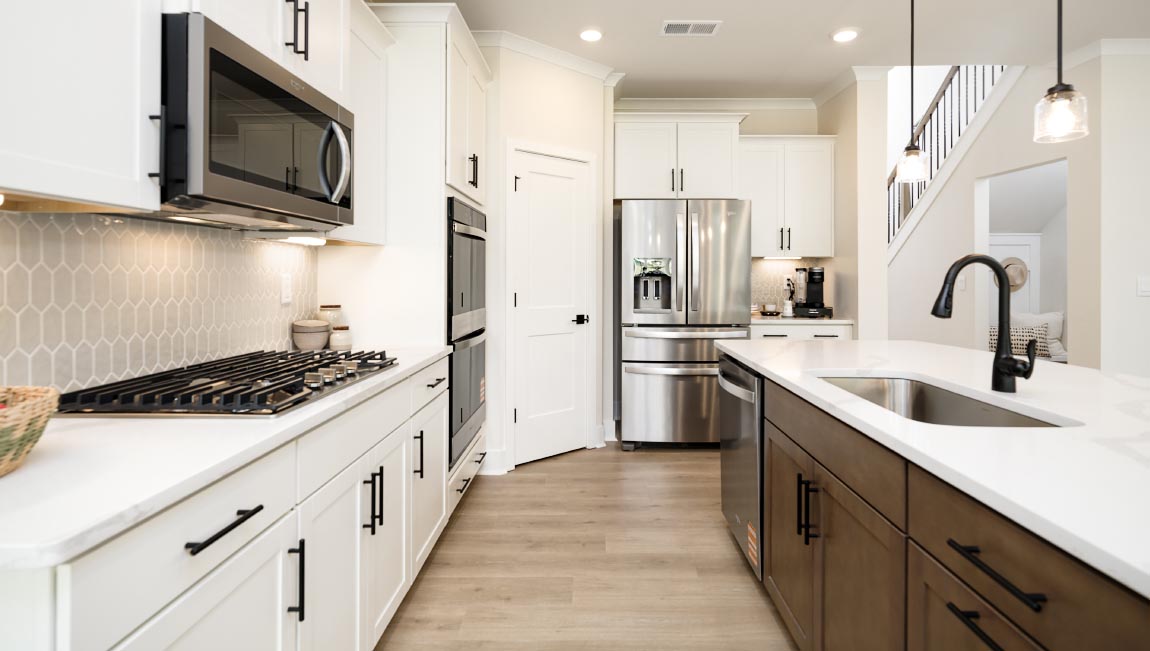 kitchen and island with white cabinets and stainless steel appliances