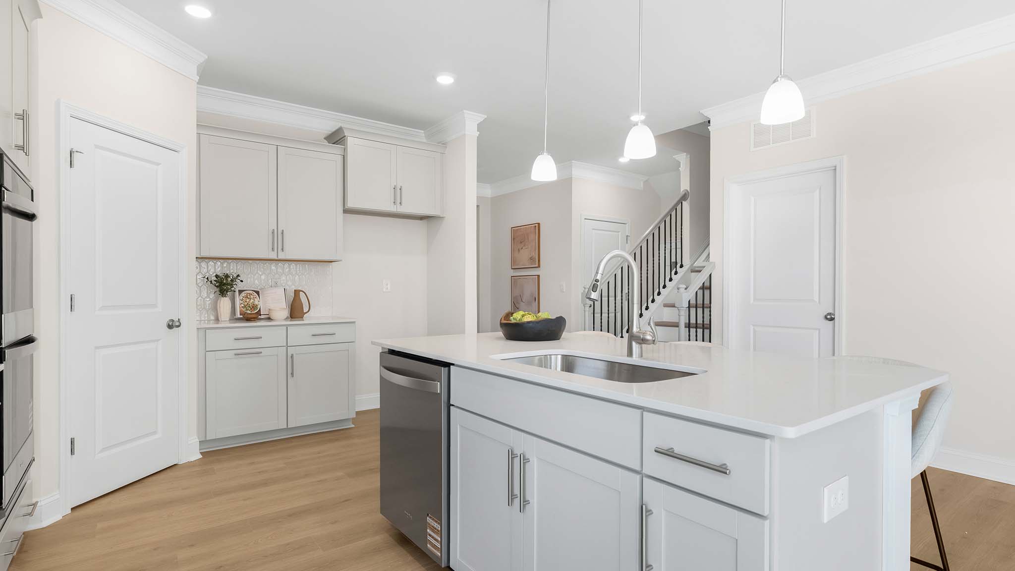 kitchen and island with white cabinets and stainless steel appliances